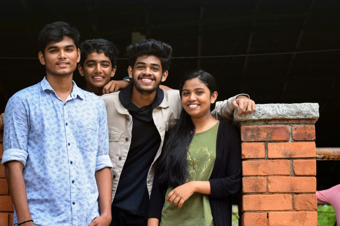 Four students together on campus.